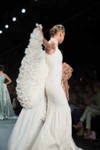 A winged model walking the runway during the John Paul Ataker NYFW collection