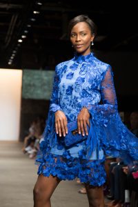 A model wearing a Jody Bell design on the runway of the NOLCHA Fashion Week