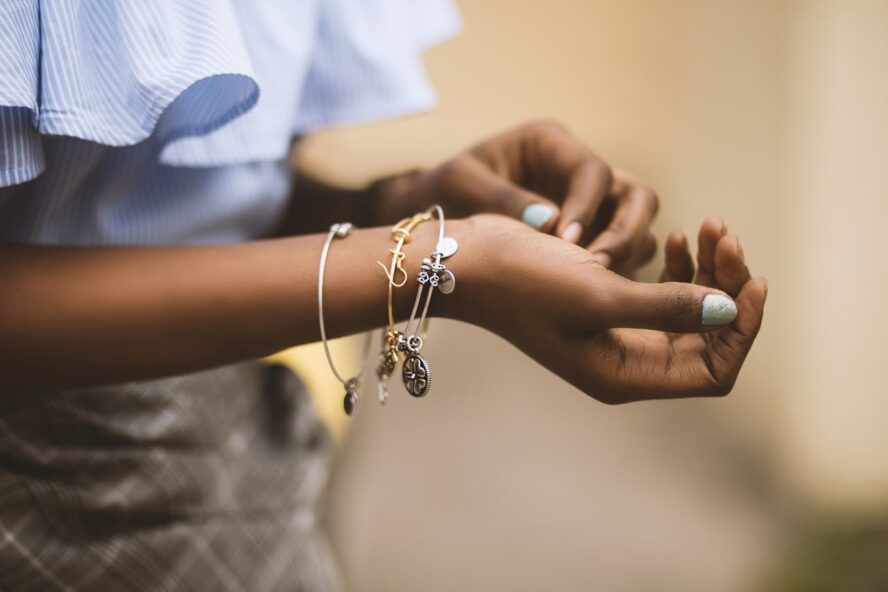 woman with multiple bracelets on arm.