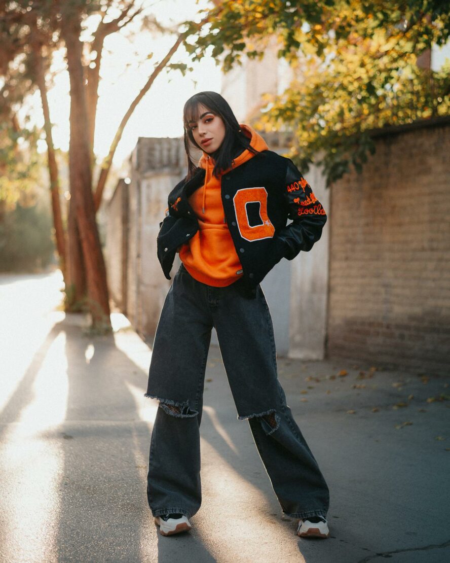 High school teenage girl wearing a varsity letter jacket.