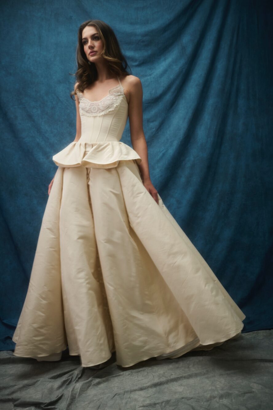 A model wearing a long cream dress.