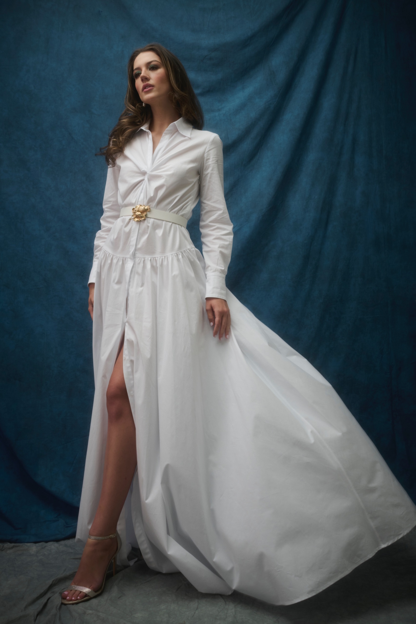 A model wearing a long white dress.