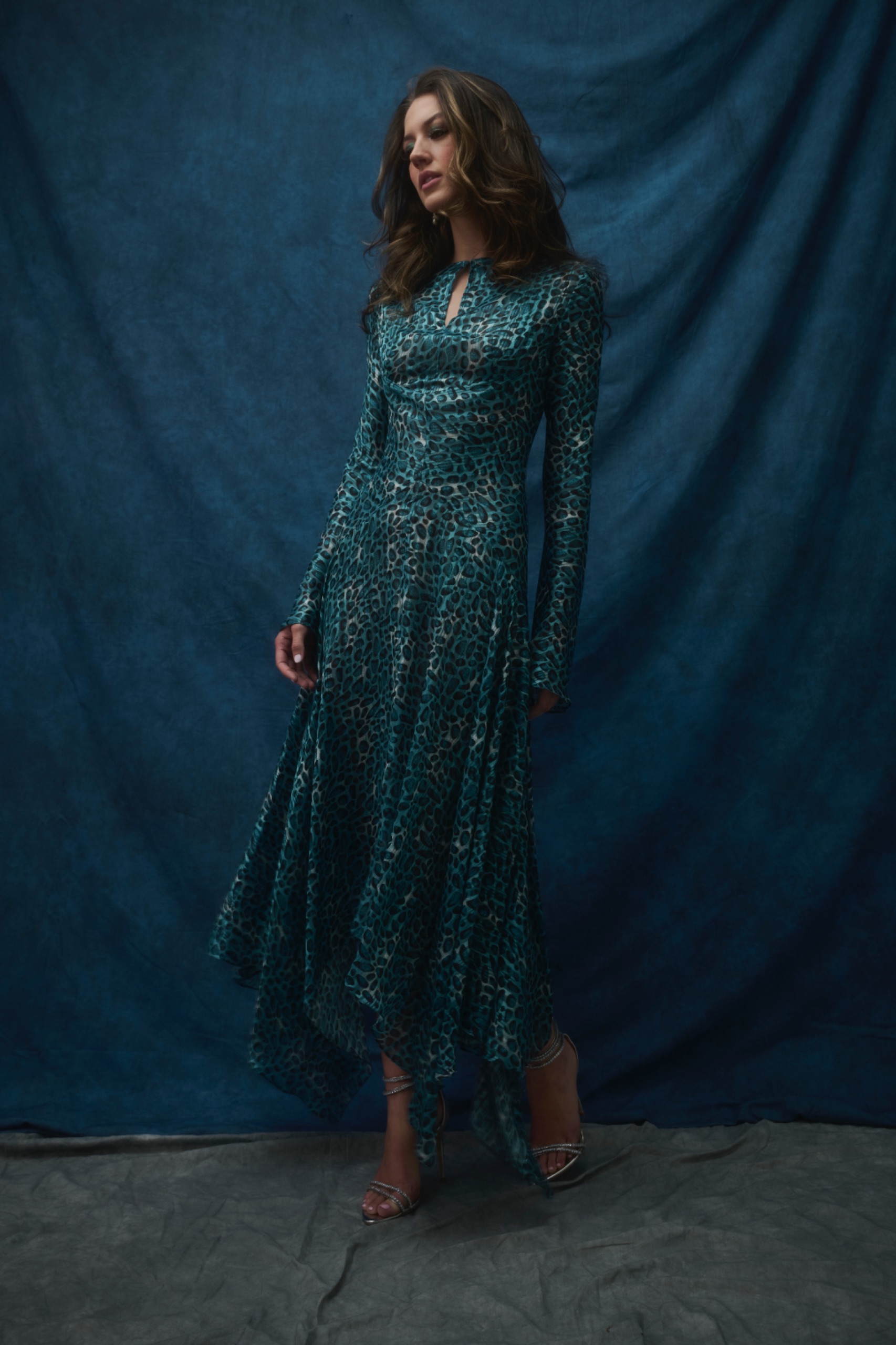 A model wearing a long green dress.