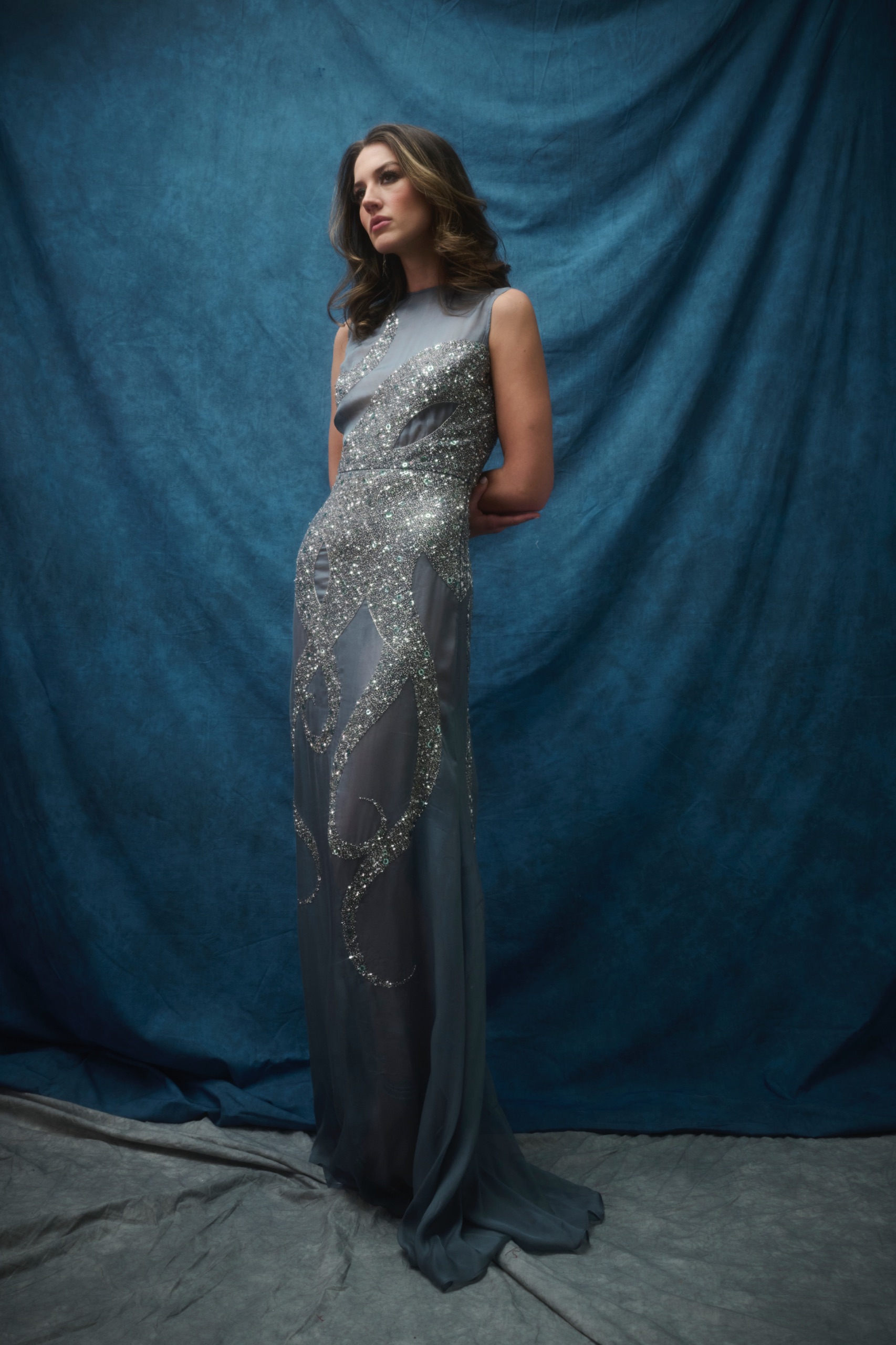 A model wearing a long grey dress.