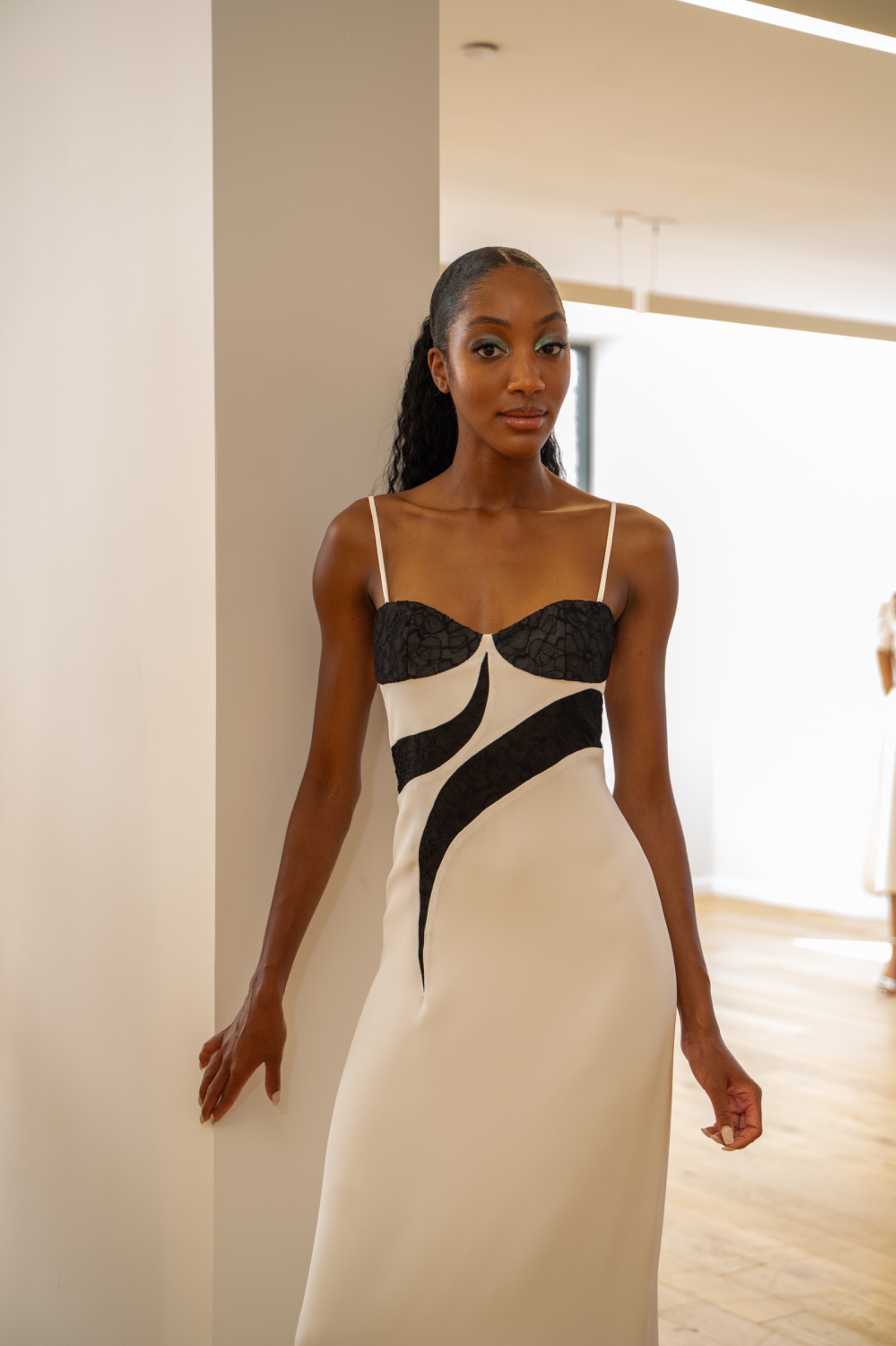 A model wearing a black and white dress.