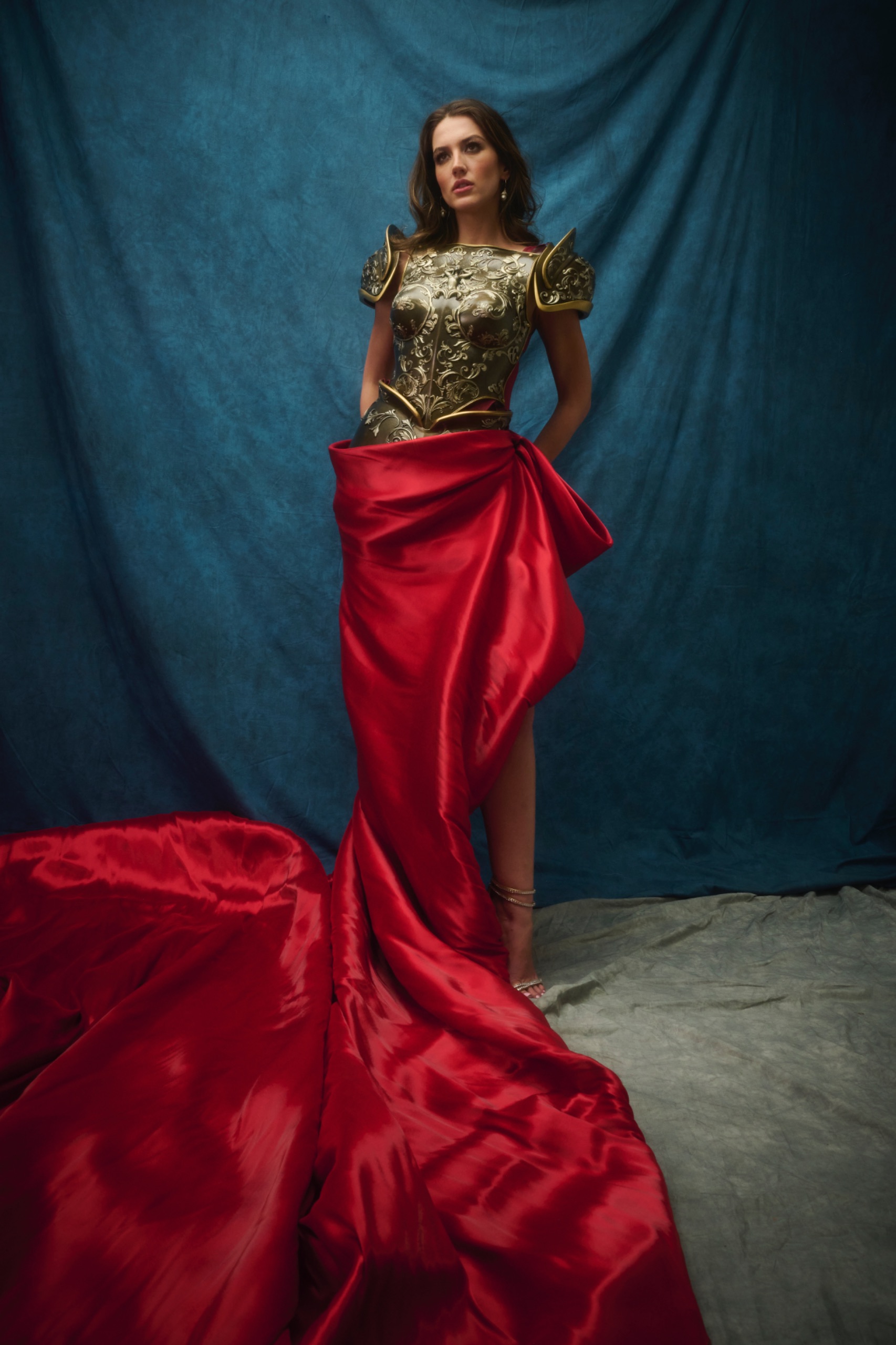 A model wearing a red and olive dress.