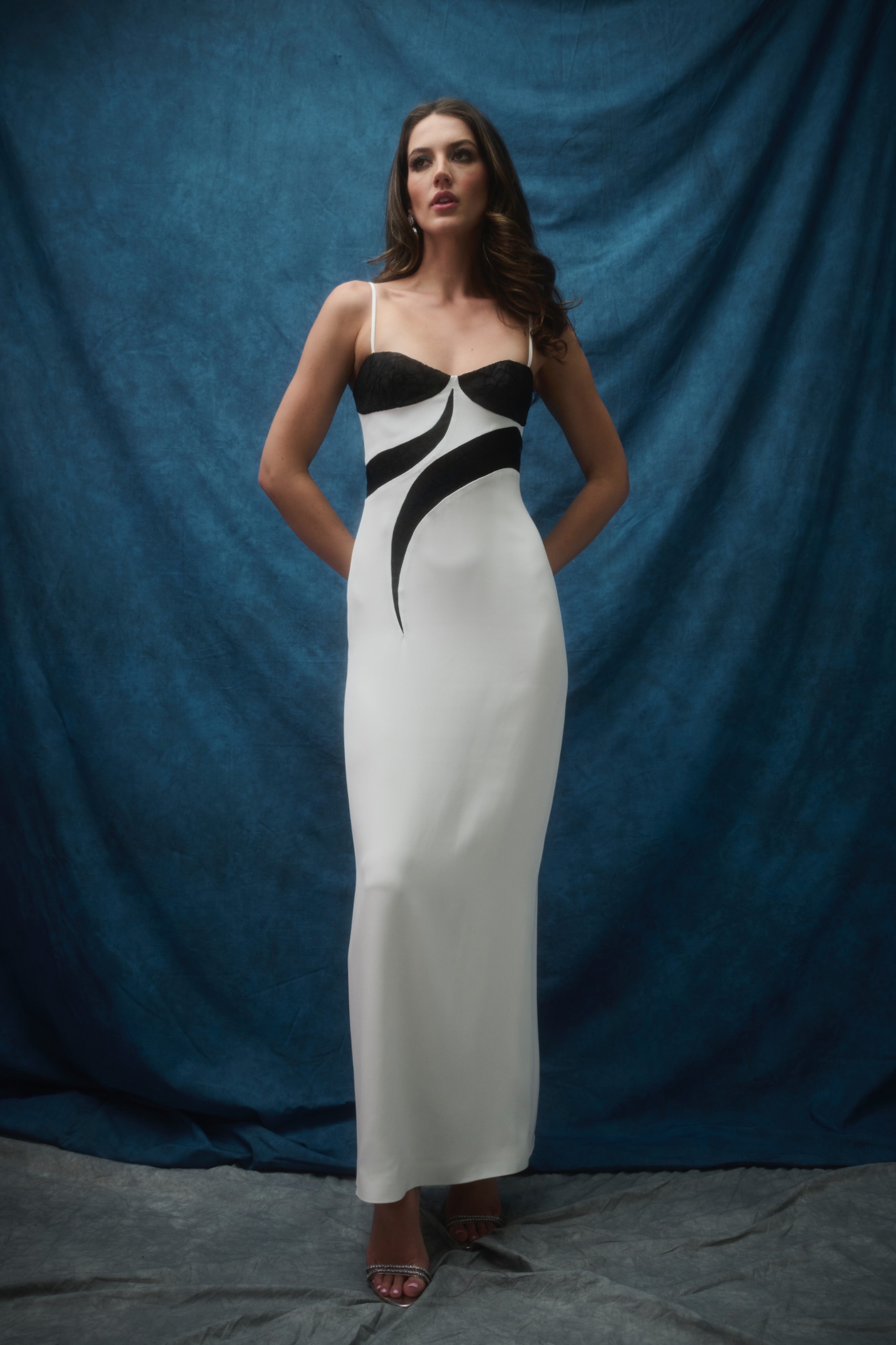 A model wearing a black and white dress.