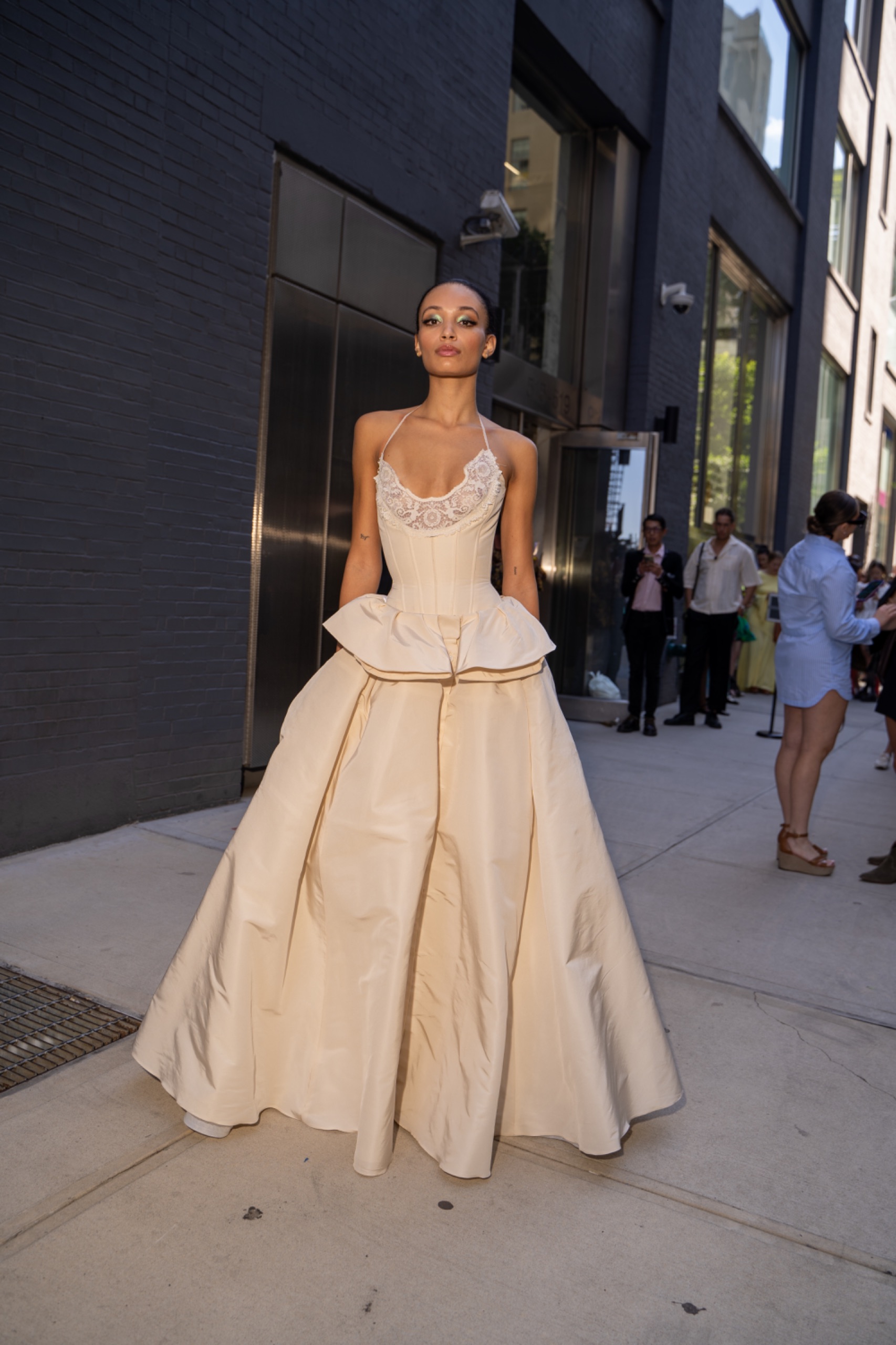 A model wearing a long white dress.