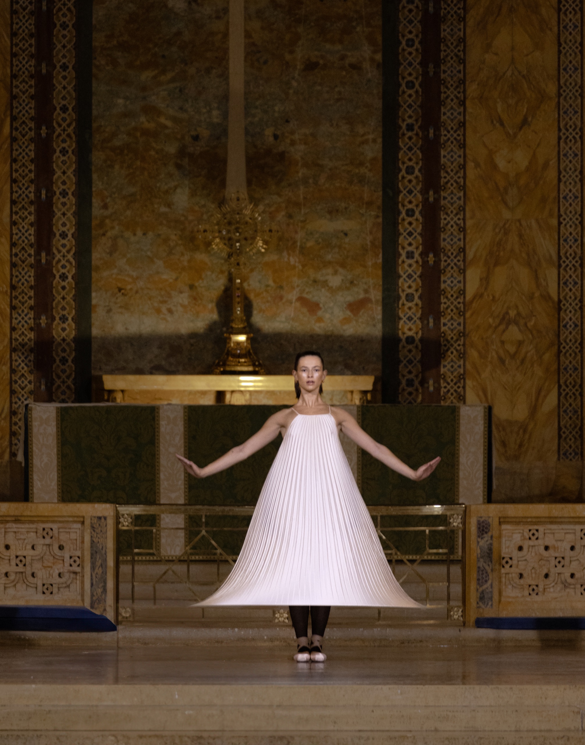 A model wearing a white dress.