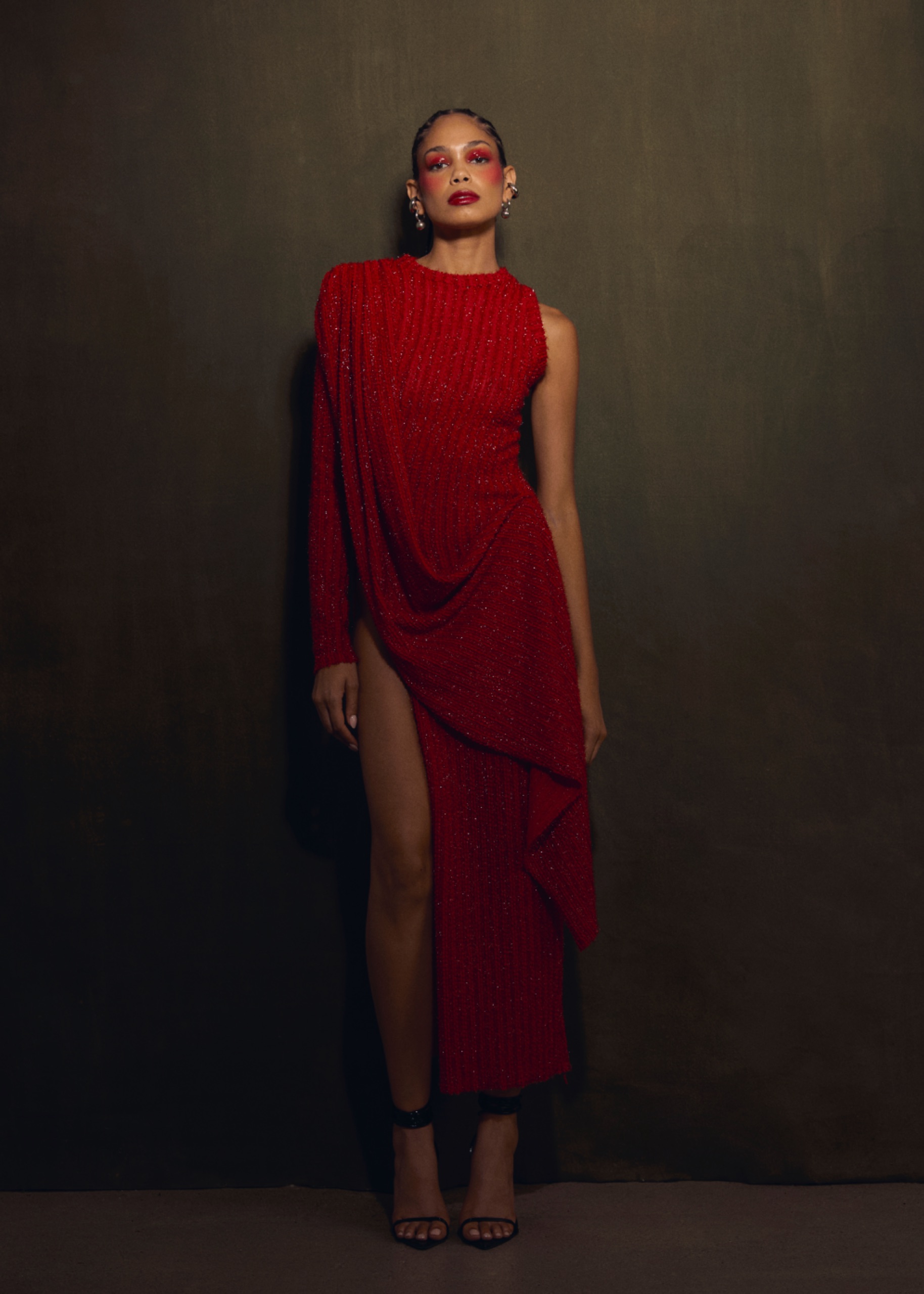 A model wearing a a long red dress.