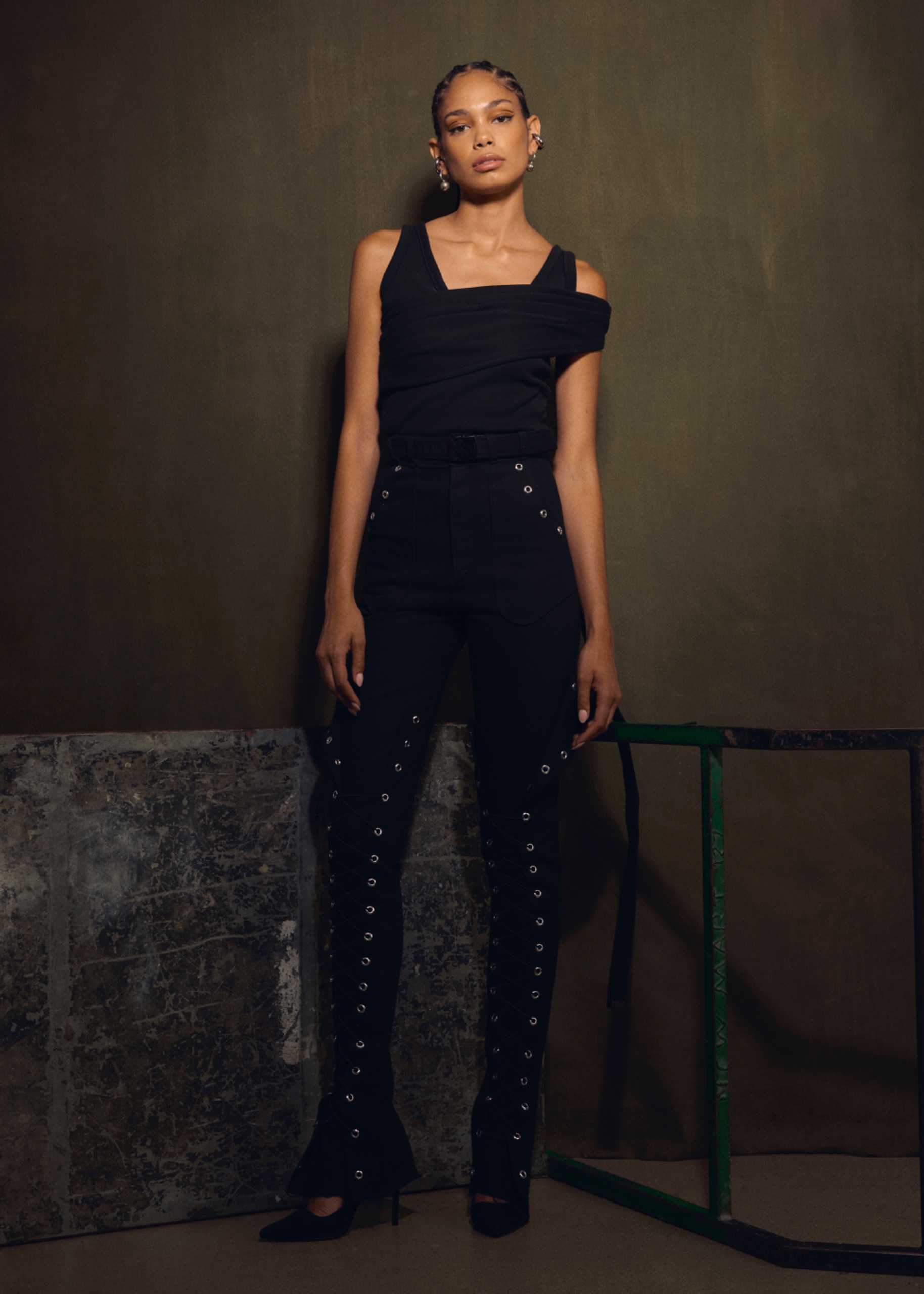 A model wearing a black top and black pants.