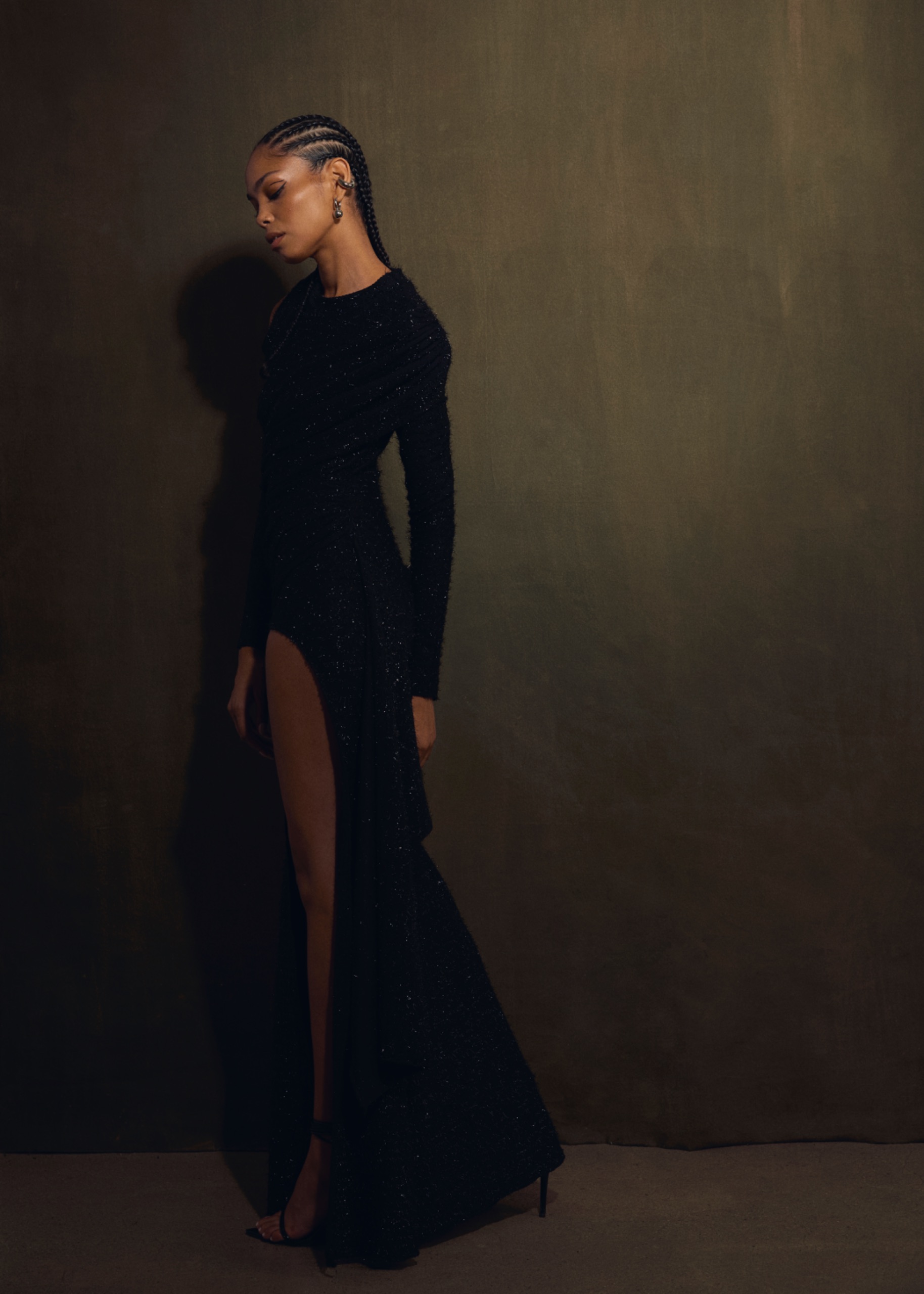 A model wearing a long black dress.