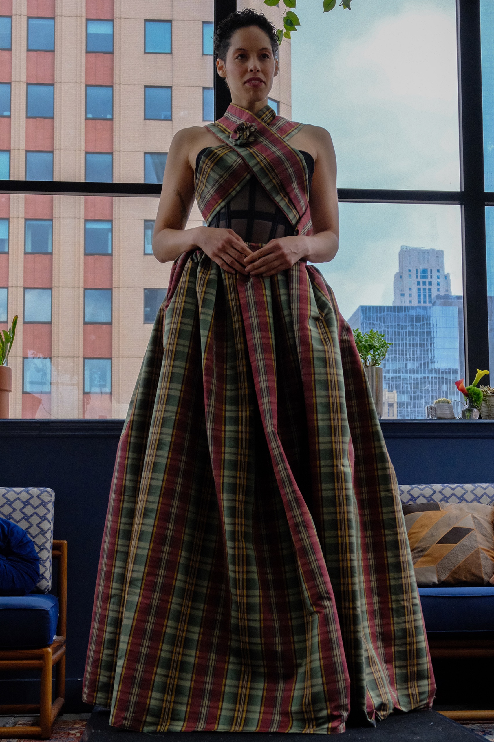 A model wearing long tartan dress.