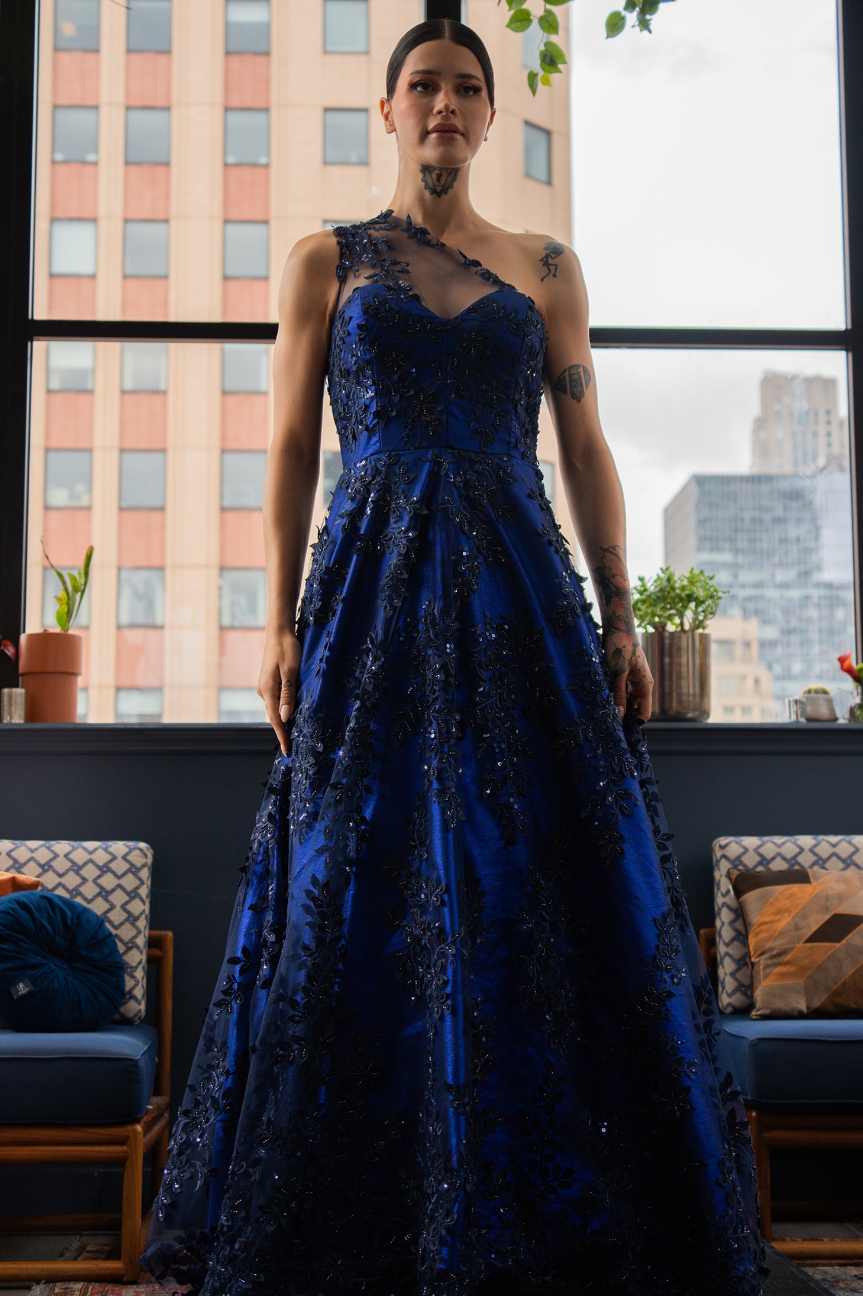 A model wearing a long navy dress.