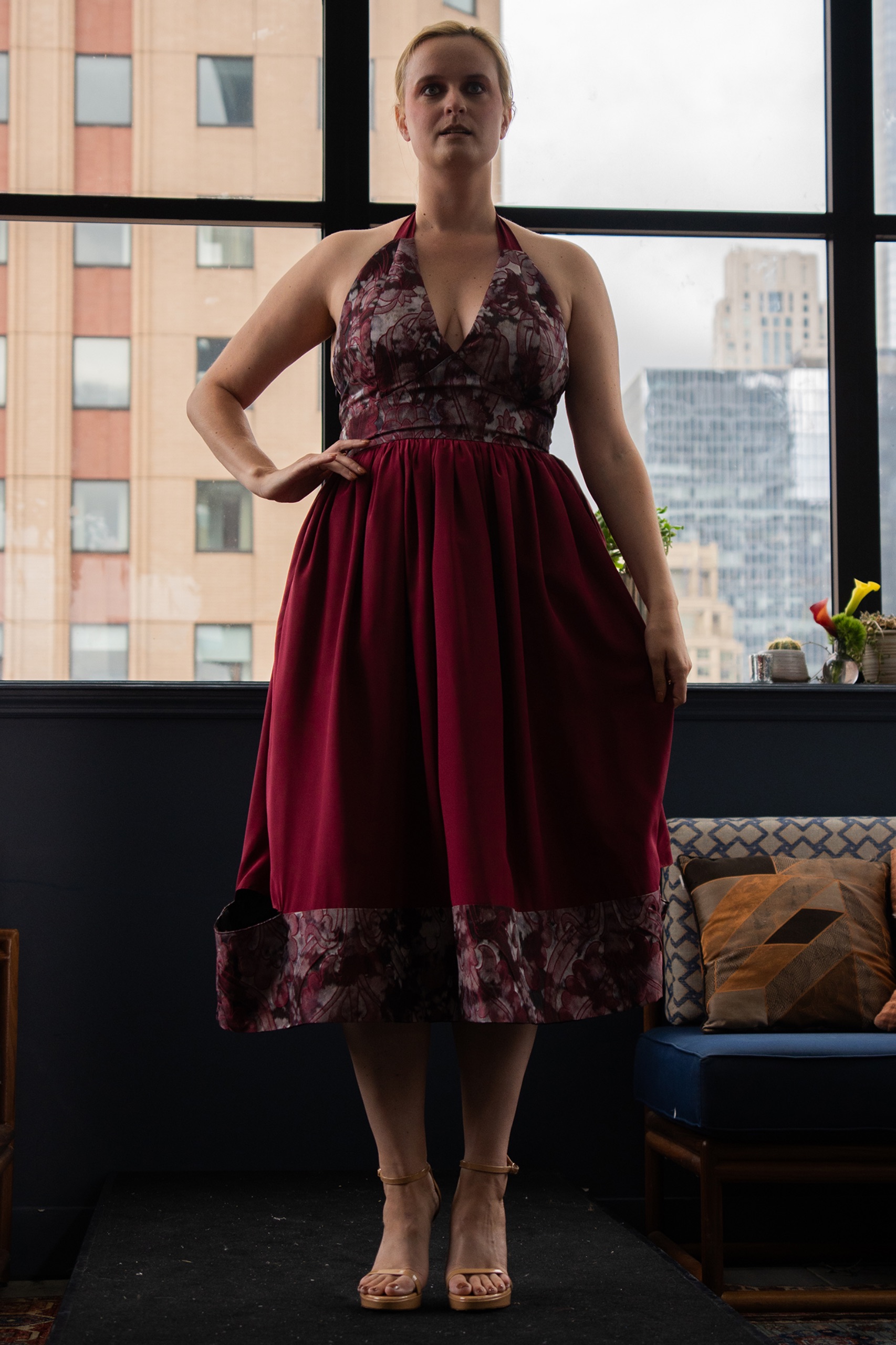 A model wearing a maroon dress.