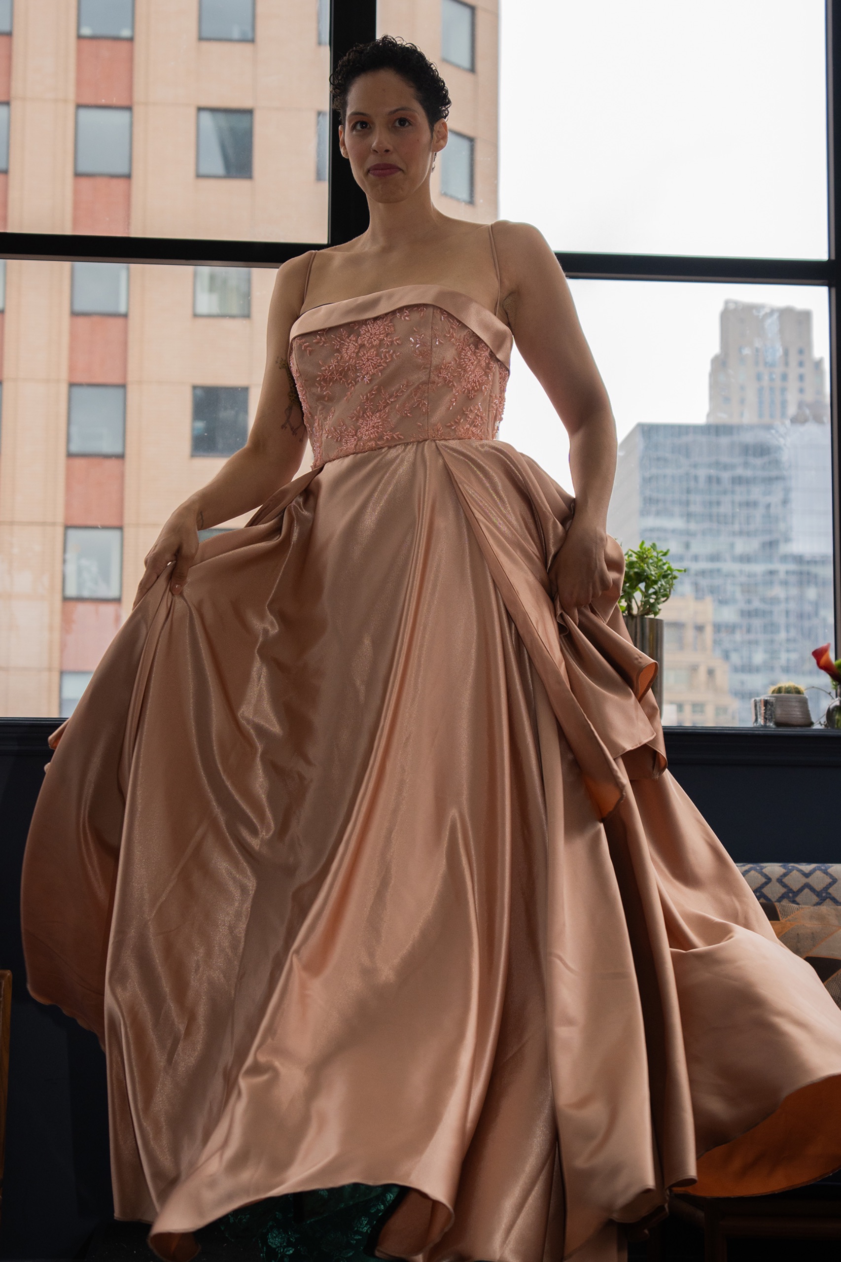 A model wearing a long copper dress.