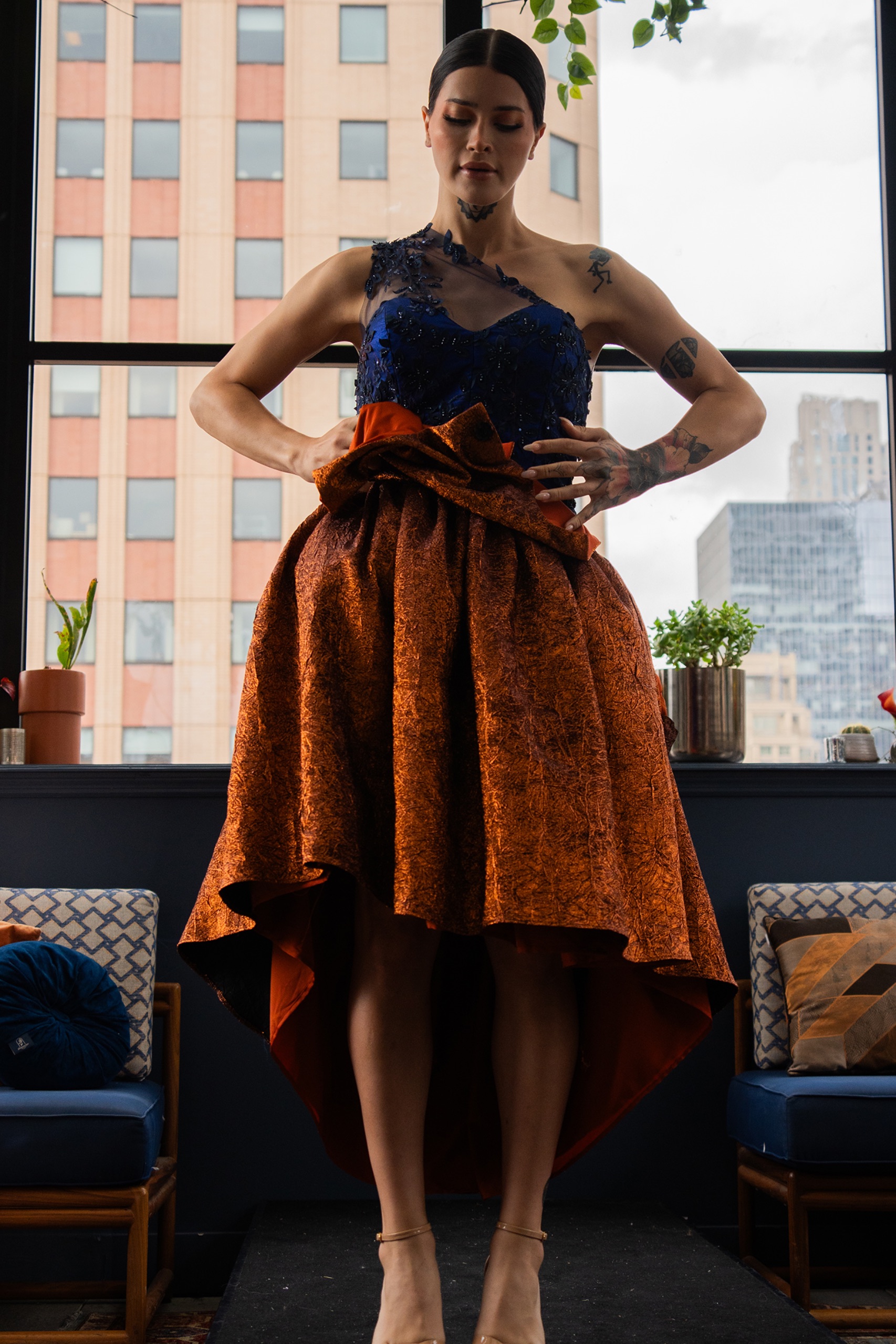 A model wearing a blue and orange dress.