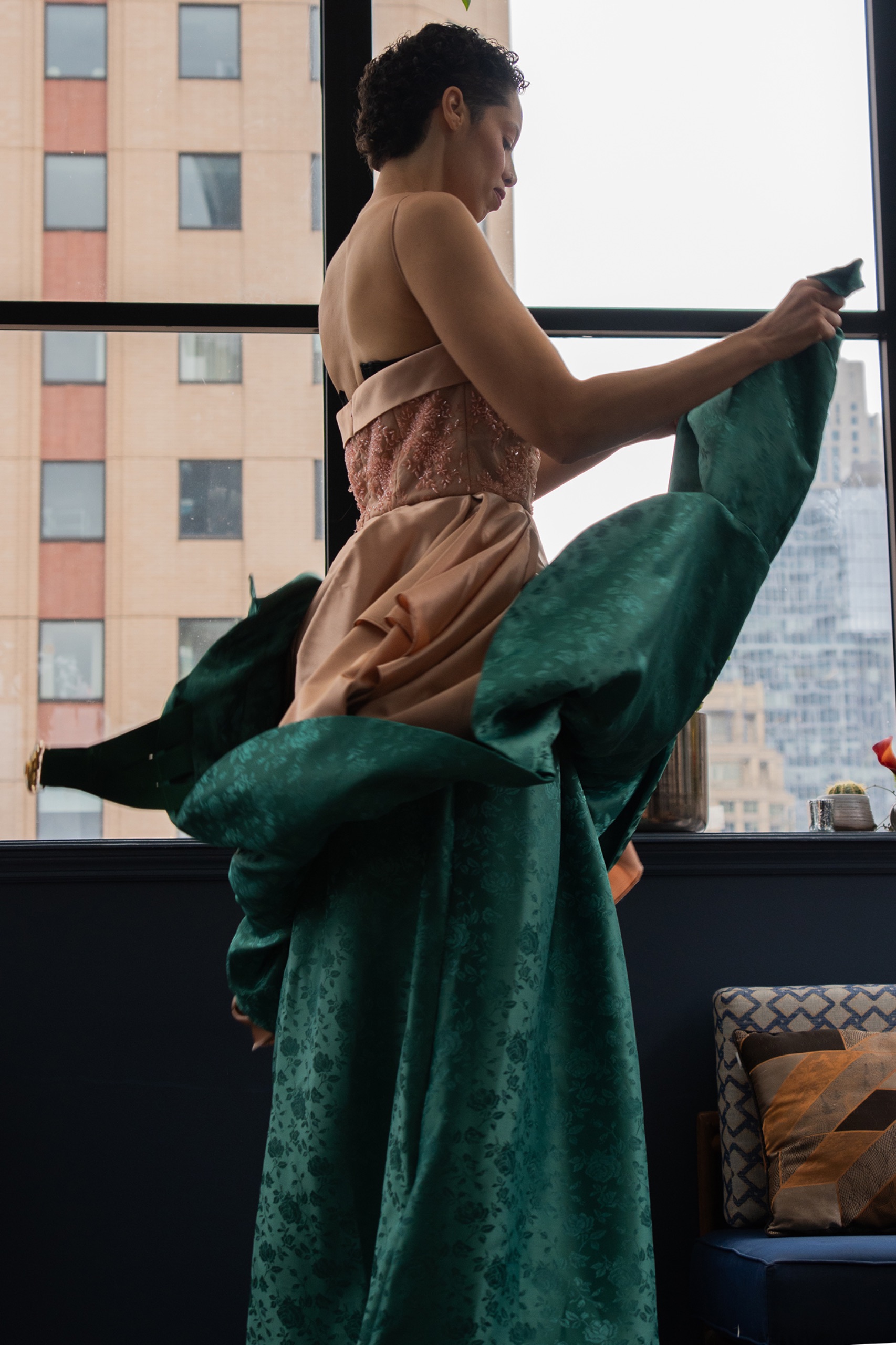 A model wearing a long green dress.