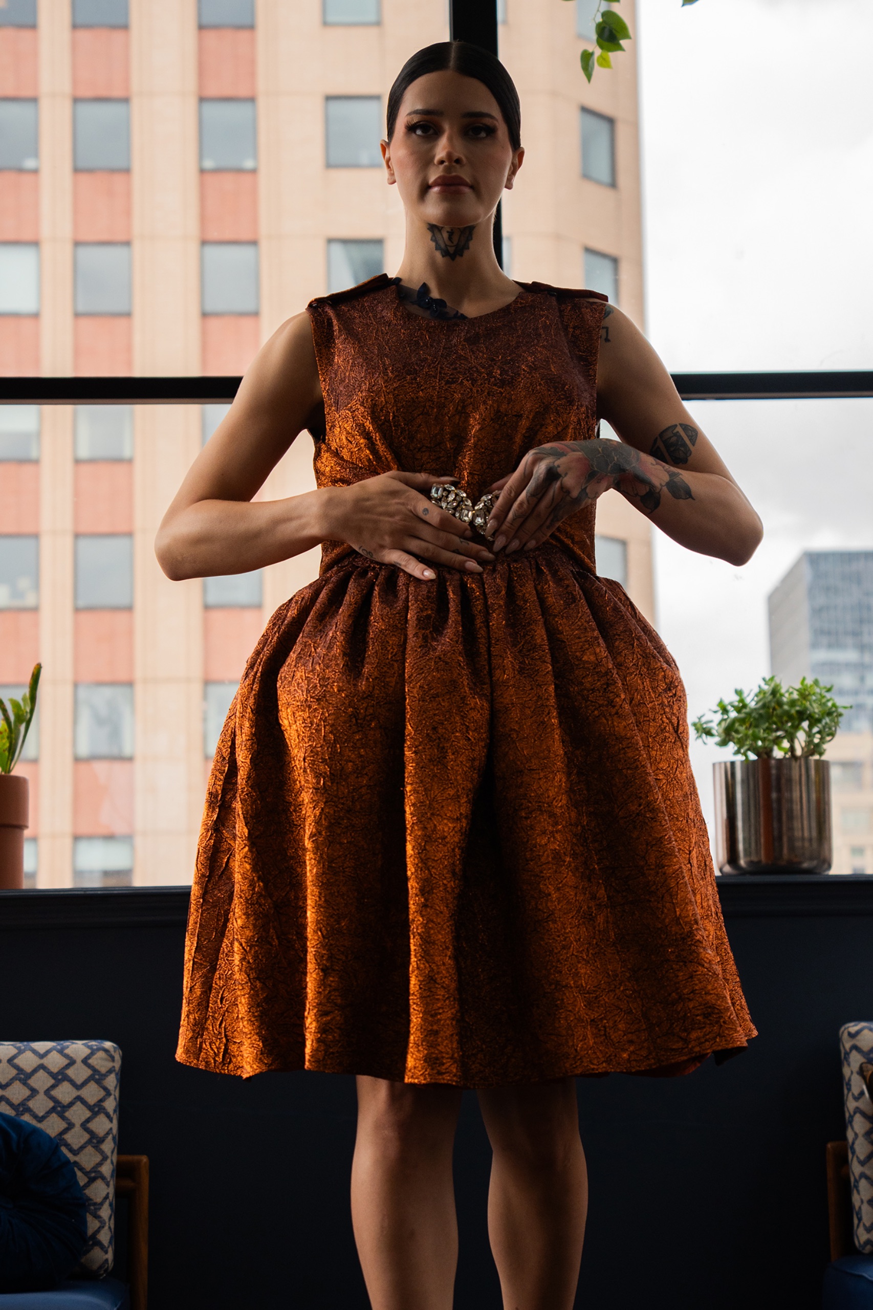 A model wearing an orange dress.