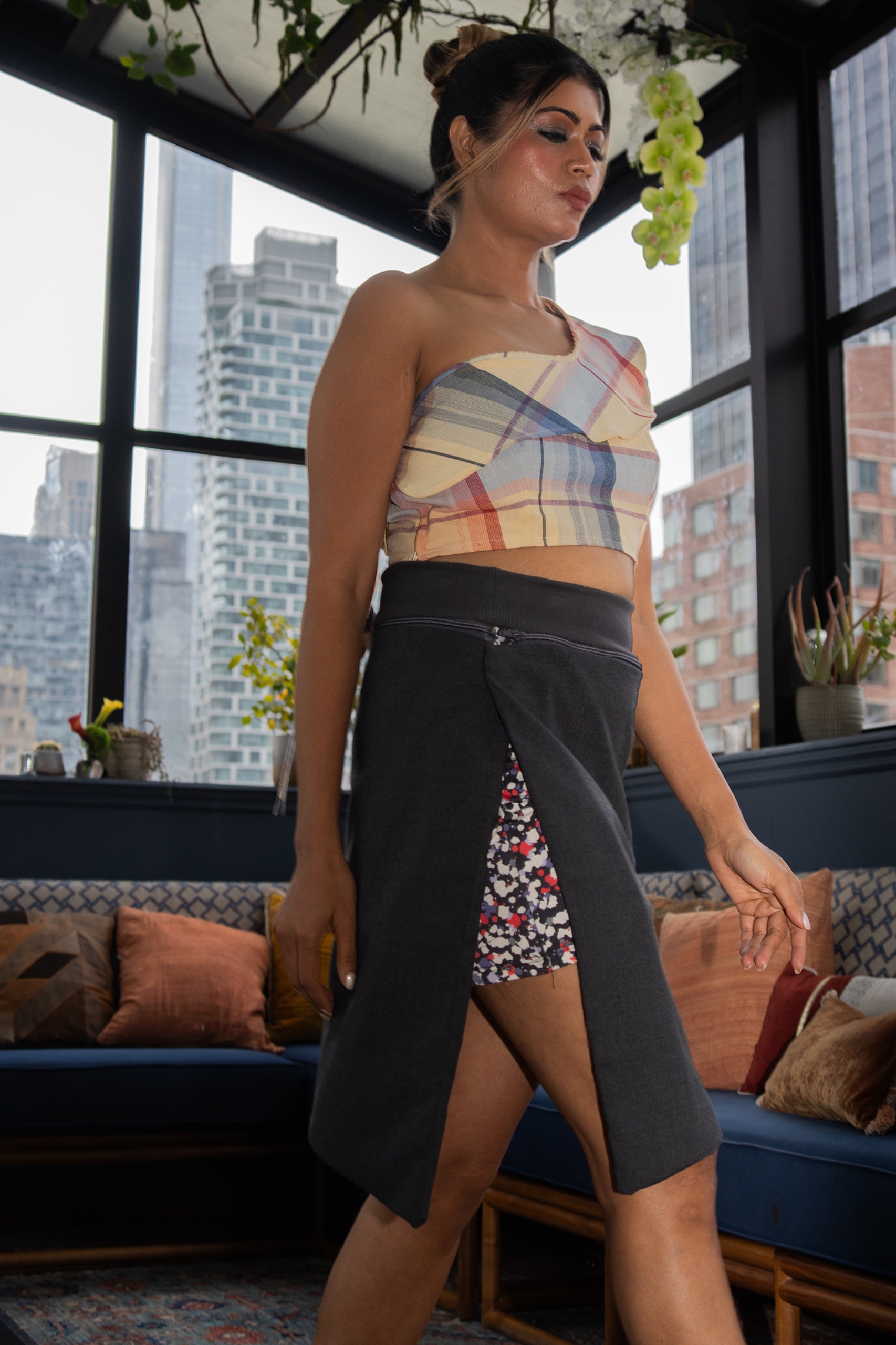 A model wearing a patterned top and skirt.